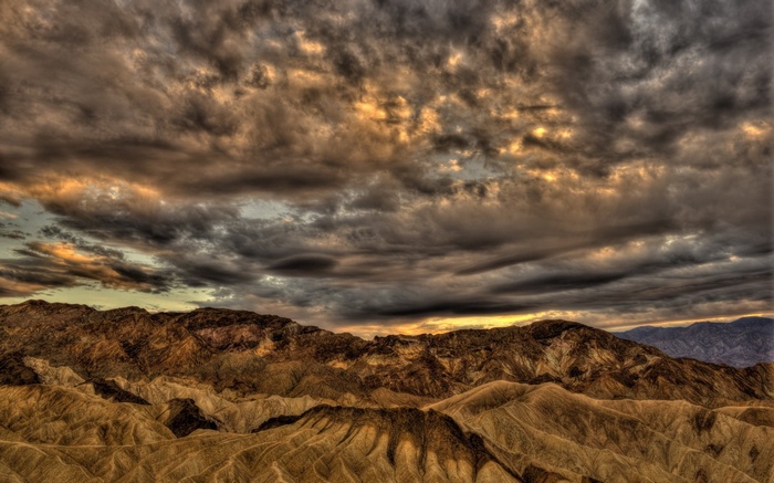 Dramatic sunset over rugged desert mountains