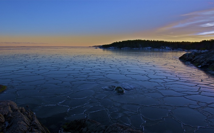 Ice floes on a calm sea at dusk