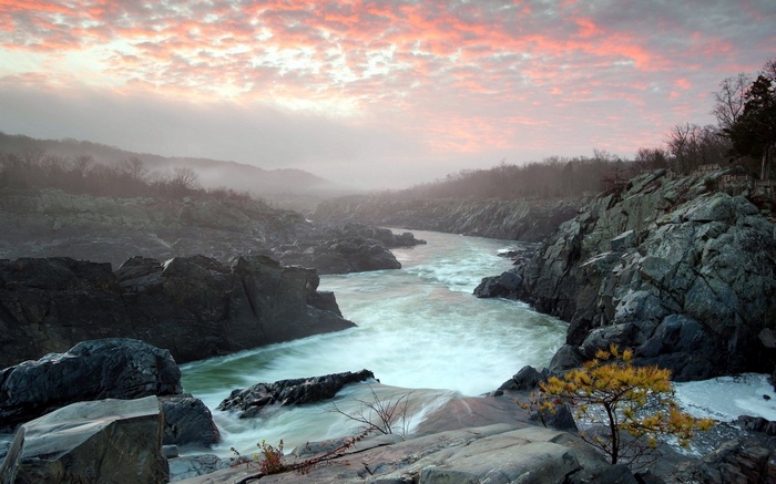 River flowing through rocky gorge at sunrise