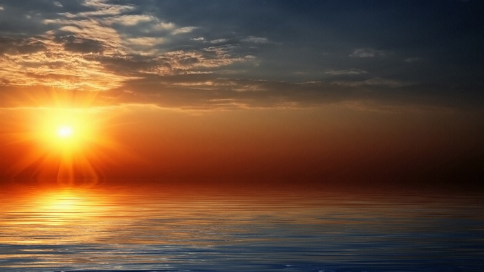 Sunset over the ocean with clouds