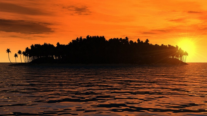 Tropical island silhouette at sunset over the ocean