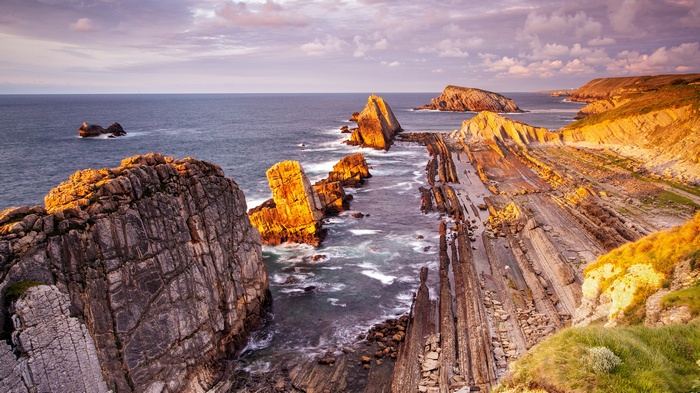 Rugged coastline with dramatic rock formations at sunset