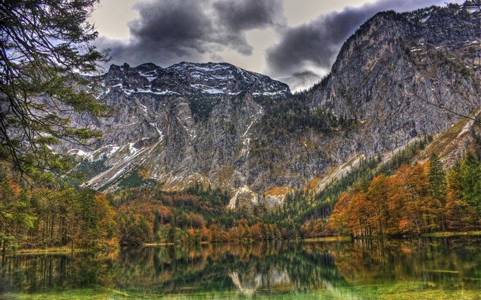 Mountain lake with autumn trees and reflection