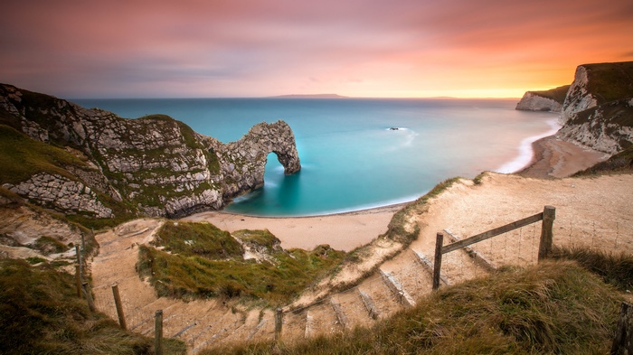 Durdle Door arch and beach at sunset