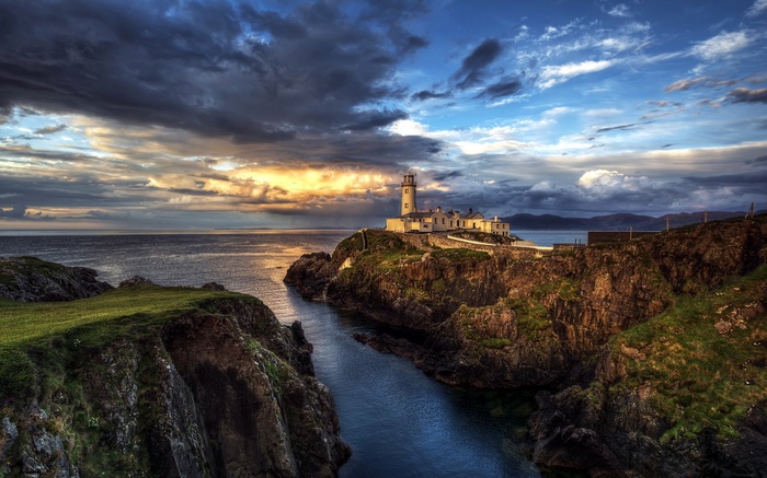 Lighthouse on a rocky cliff overlooking the sea