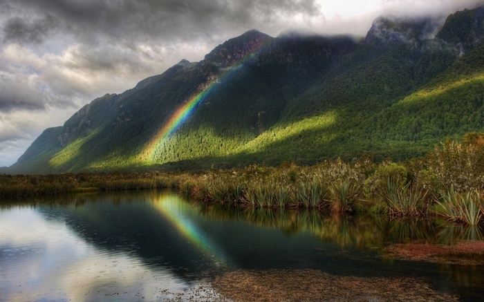 Rainbow over a lake and mountains