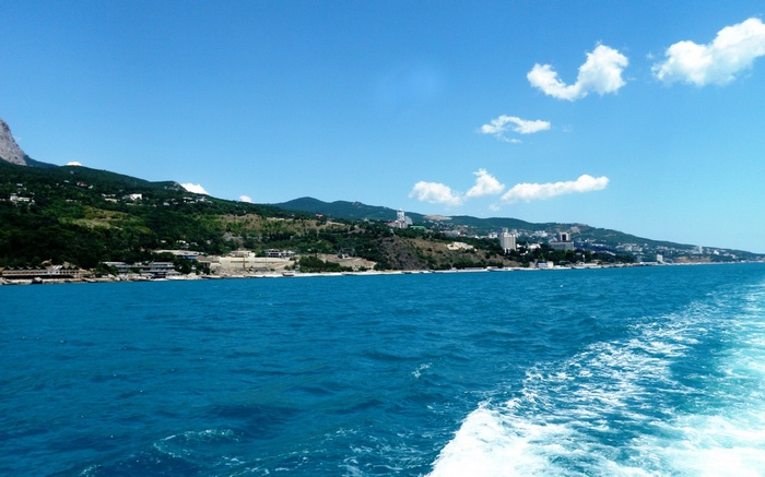 Coastal city with mountains and blue sea