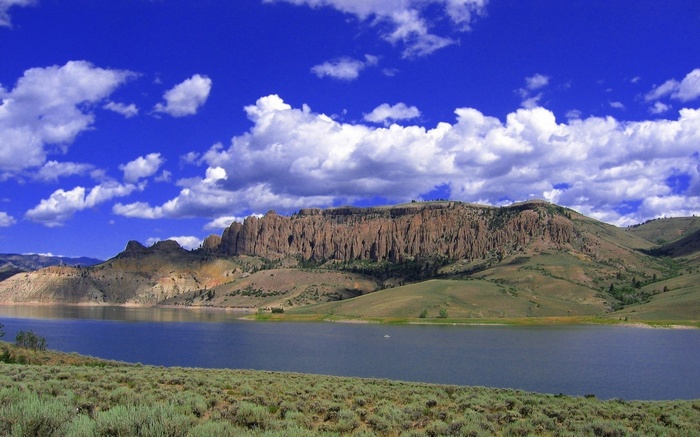 Lake and Mountains Under a Blue Sky with Clouds