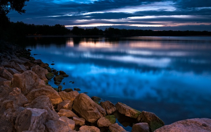 Rocky shore of a lake at dusk