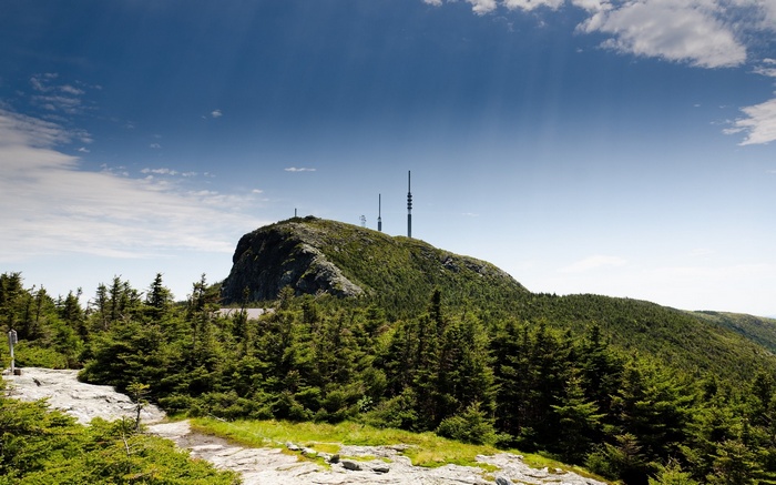 Mountain peak with trees and communication towers