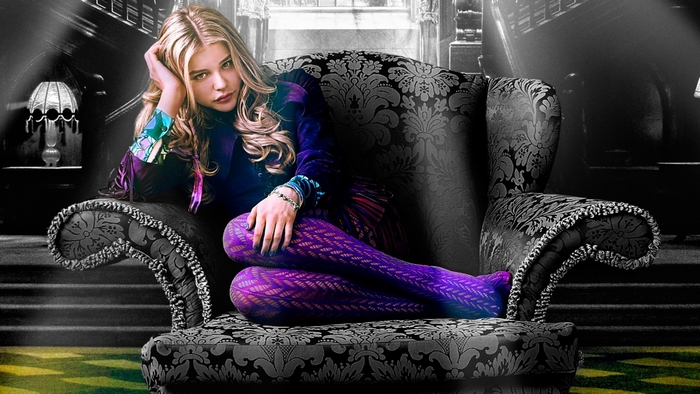 Chloe Grace Moretz sitting in a chair