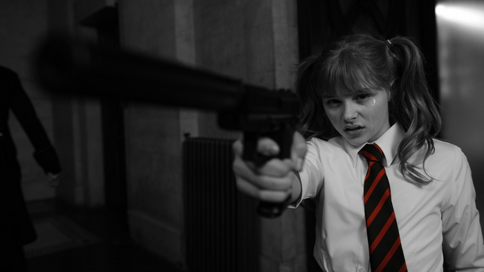 Chloe Grace Moretz Pointing Silenced Pistol