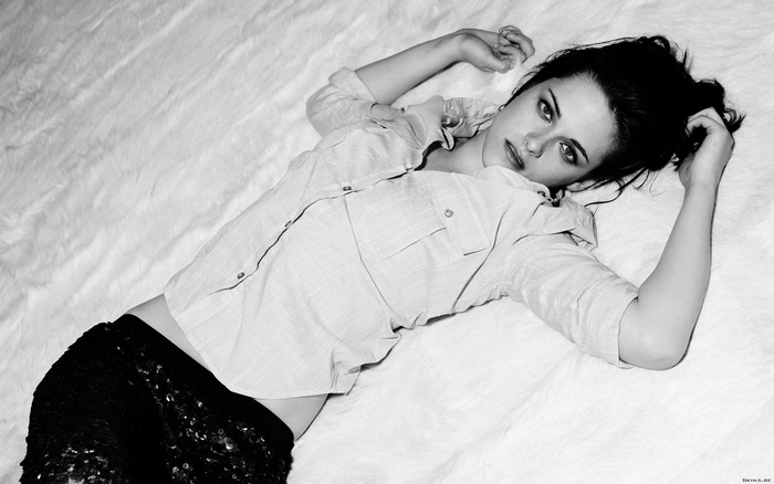Kristen Stewart lying on a white furry surface