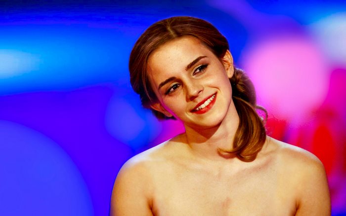 Emma Watson Smiling with Colorful Blurred Background