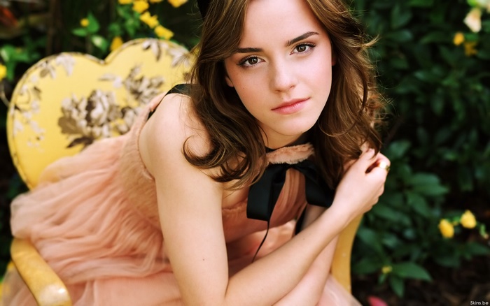 Emma Watson sitting on a yellow chair