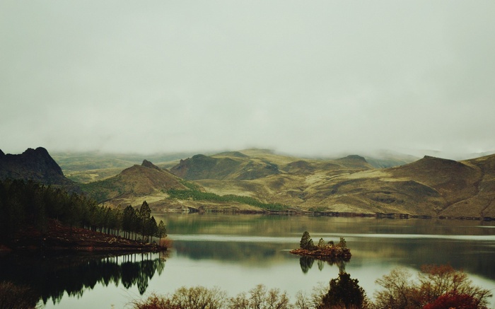 Lake and mountains under a cloudy sky