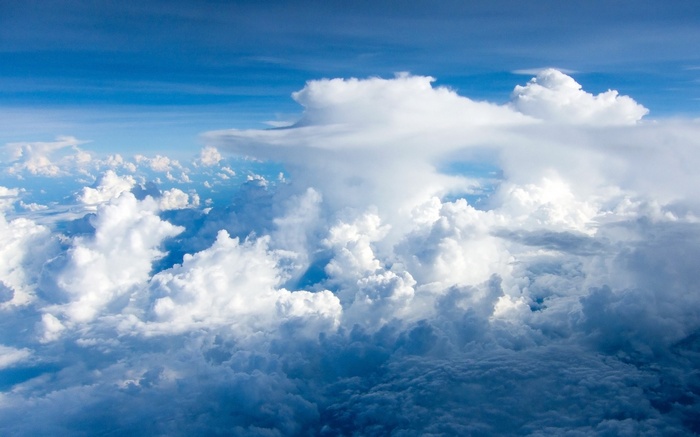 Cumulus clouds in a blue sky from above