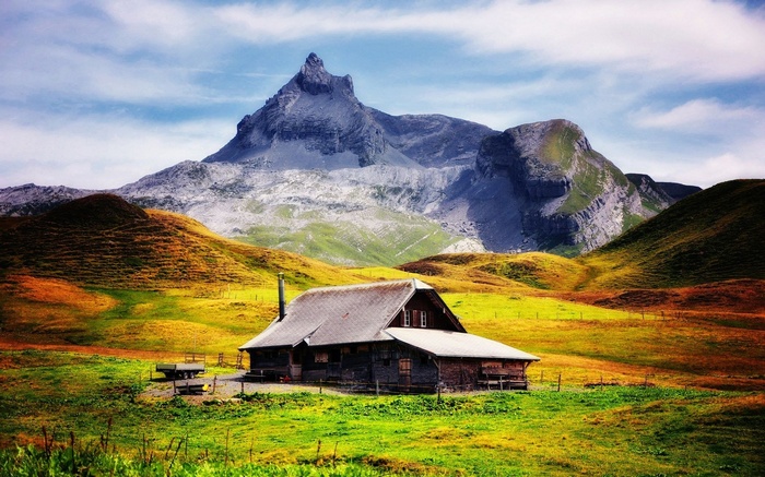 Wooden cabin in a mountain landscape
