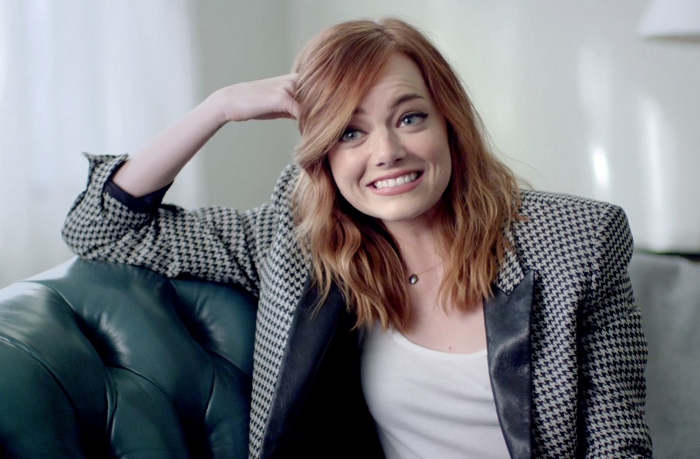 Emma Stone sitting on a couch