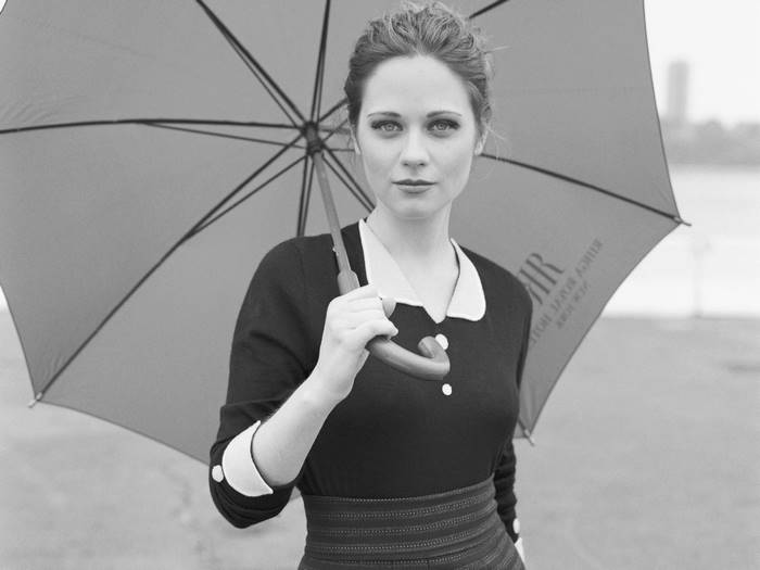 Zooey Deschanel holding an umbrella