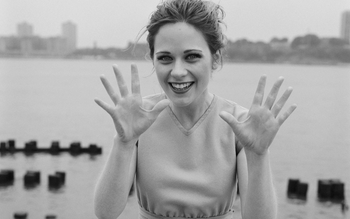 Zooey Deschanel holding up her hands