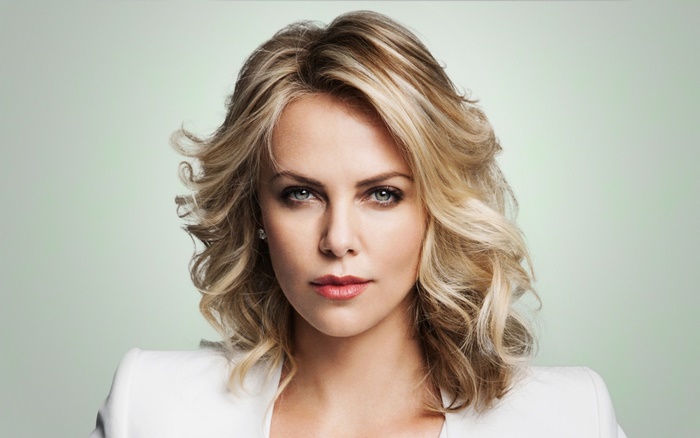 Charlize Theron in White Blazer with Confident Look