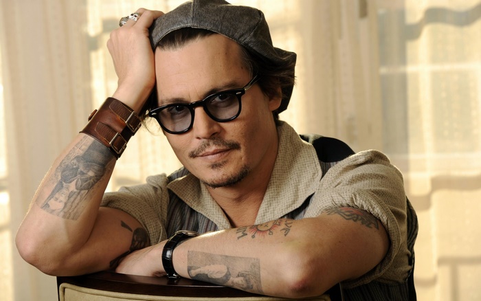 Johnny Depp wearing glasses and a cap