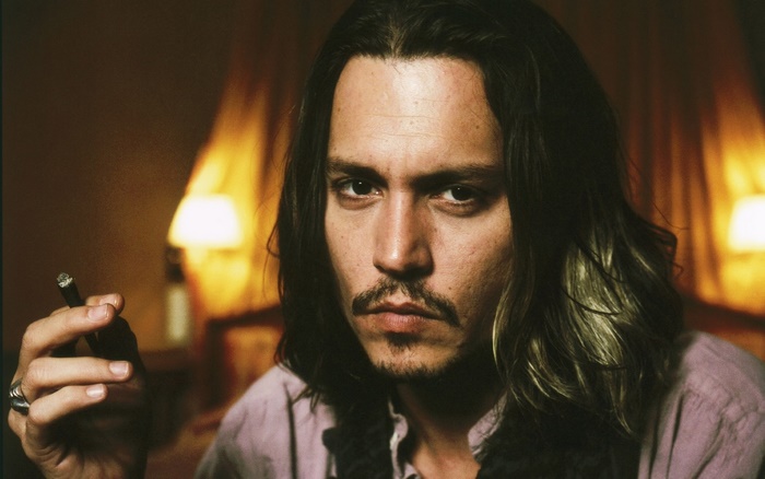 Johnny Depp holding a cigar