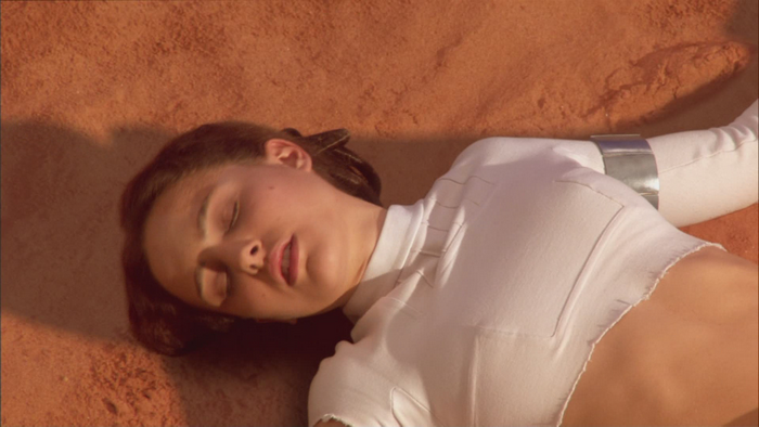 Natalie Portman lying on sand