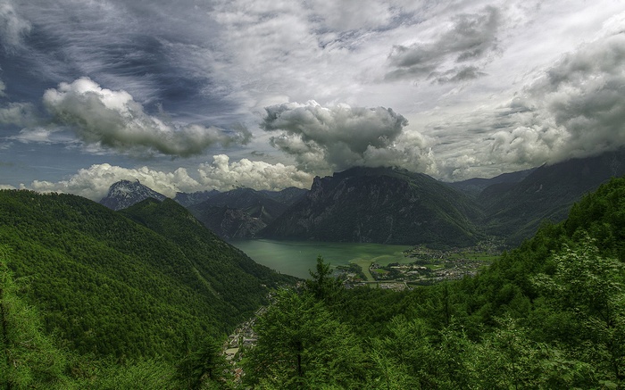 Mountain valley with a lake and dramatic clouds
