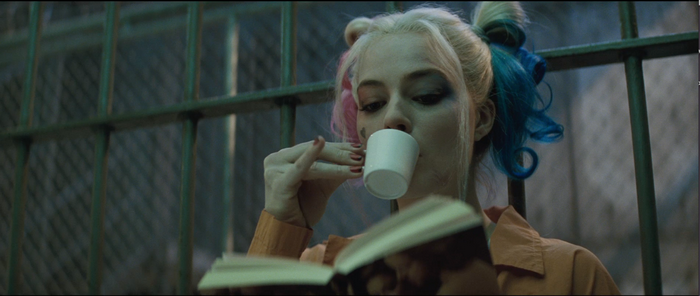 Harley Quinn from Suicide Squad drinking coffee and reading
