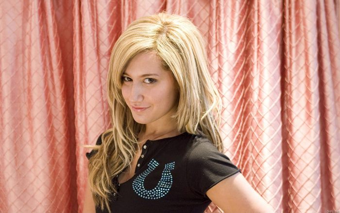 Ashley Tisdale in black shirt with horseshoe logo