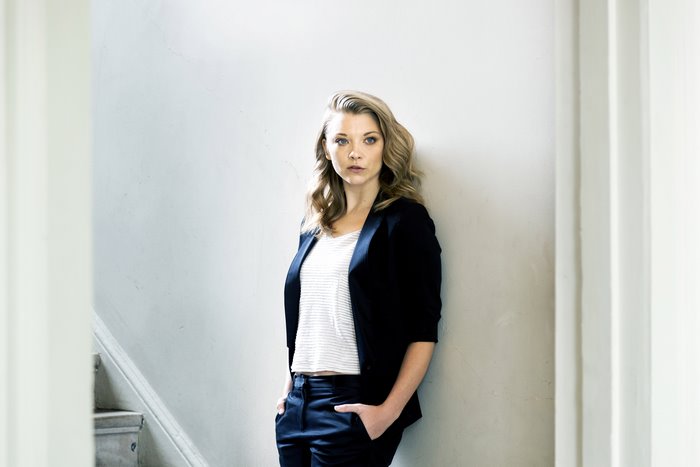 Natalie Dormer leaning against a wall