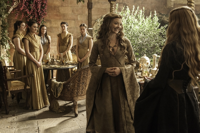 Natalie Dormer and women in gold dresses