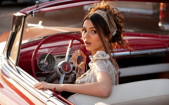 Victoria Justice in Vintage Car Holding Sunglasses