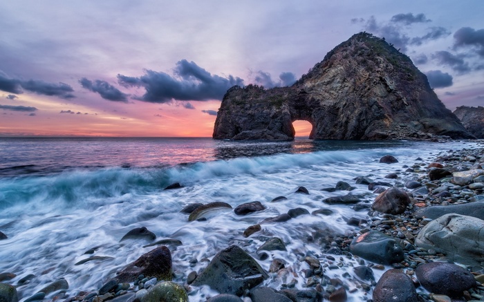 Rock Archway Overlooking Ocean at Sunset