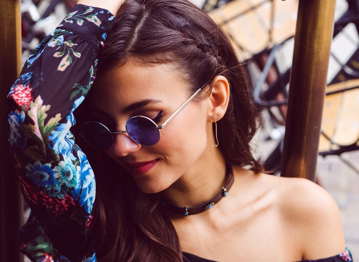 Victoria Justice wearing sunglasses and a floral top