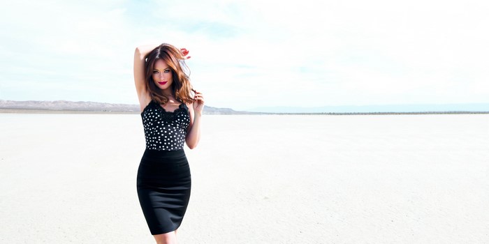 Olivia Wilde in a black polka dot top and skirt