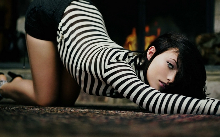 Olivia Wilde on a rug near a fireplace
