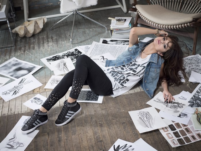Selena Gomez lying on the floor with sketches