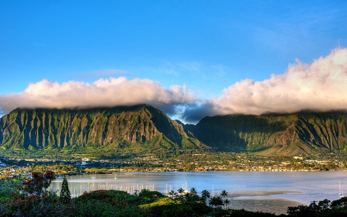 Mountains with clouds over a bay with boats