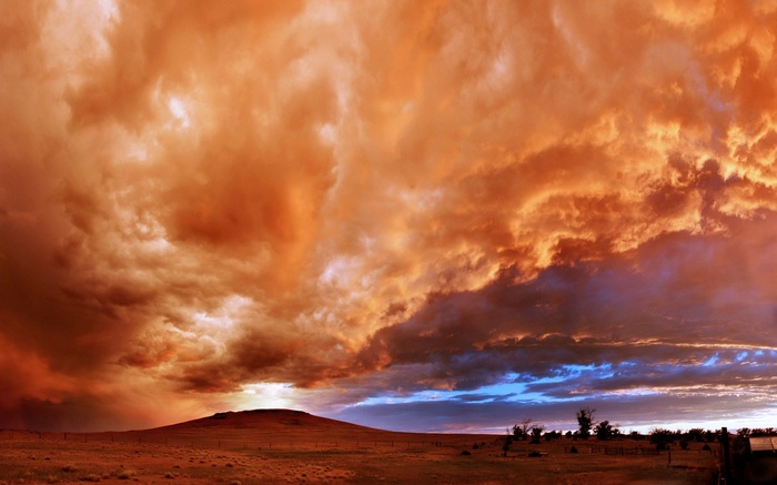 Dramatic sunset clouds over a prairie landscape