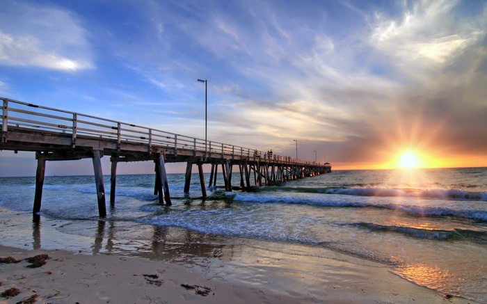 Pier at sunset over the ocean