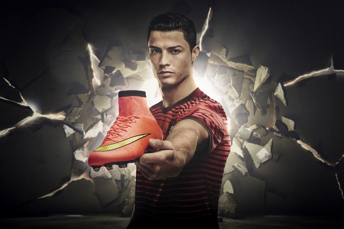 Cristiano Ronaldo holding a Nike soccer cleat