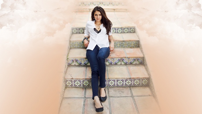 Nina Dobrev sitting on ornate tiled stairs