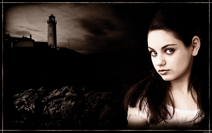 Mila Kunis in front of a lighthouse