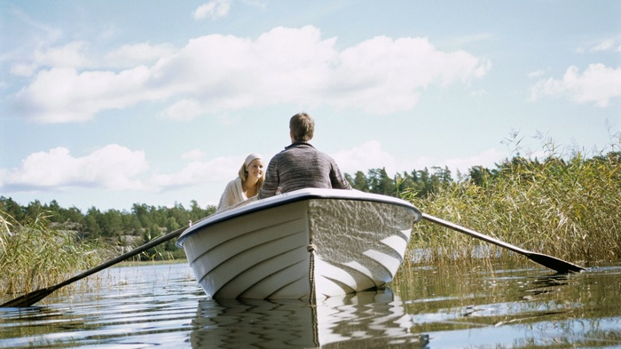 Couple rowing a boat on a lake