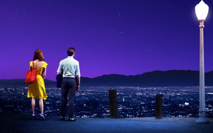 Ryan Gosling and Emma Stone overlooking city at night