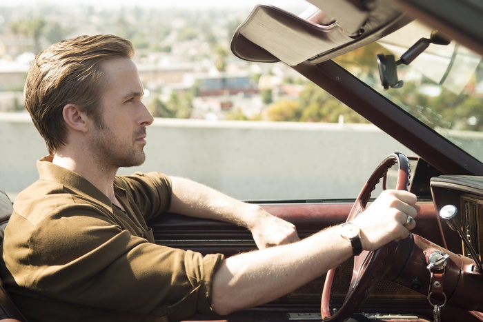 Ryan Gosling driving a convertible