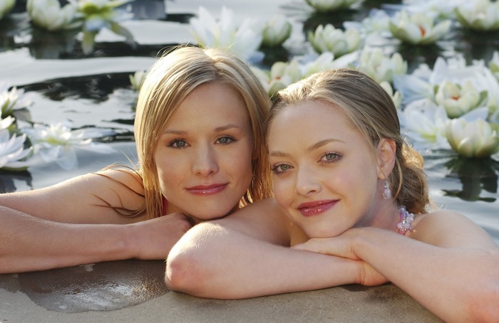 Kristen Bell and Amanda Seyfried in water with lilies